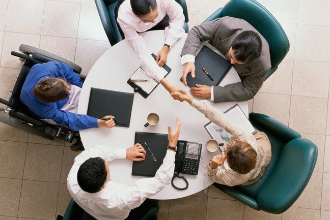 A group of people sitting around a table.