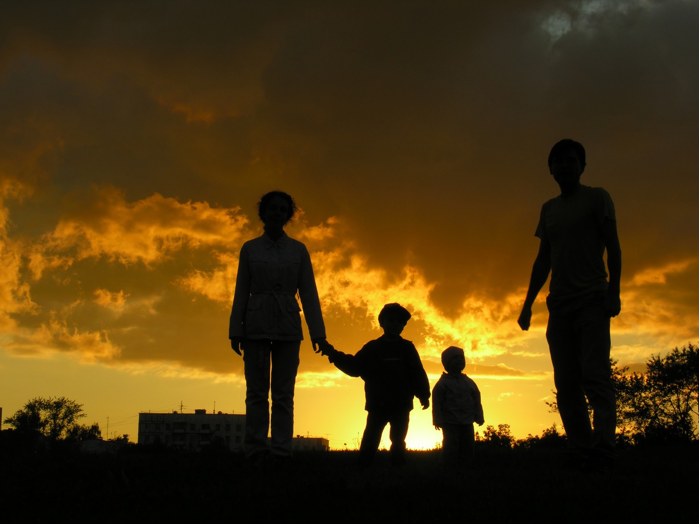 A group of people standing on top of a grass covered field.