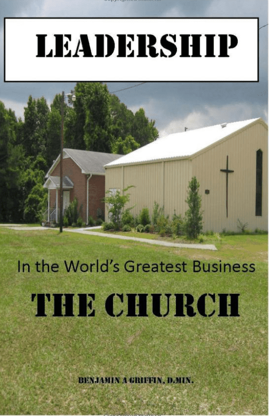 A church with grass and trees in front of it.