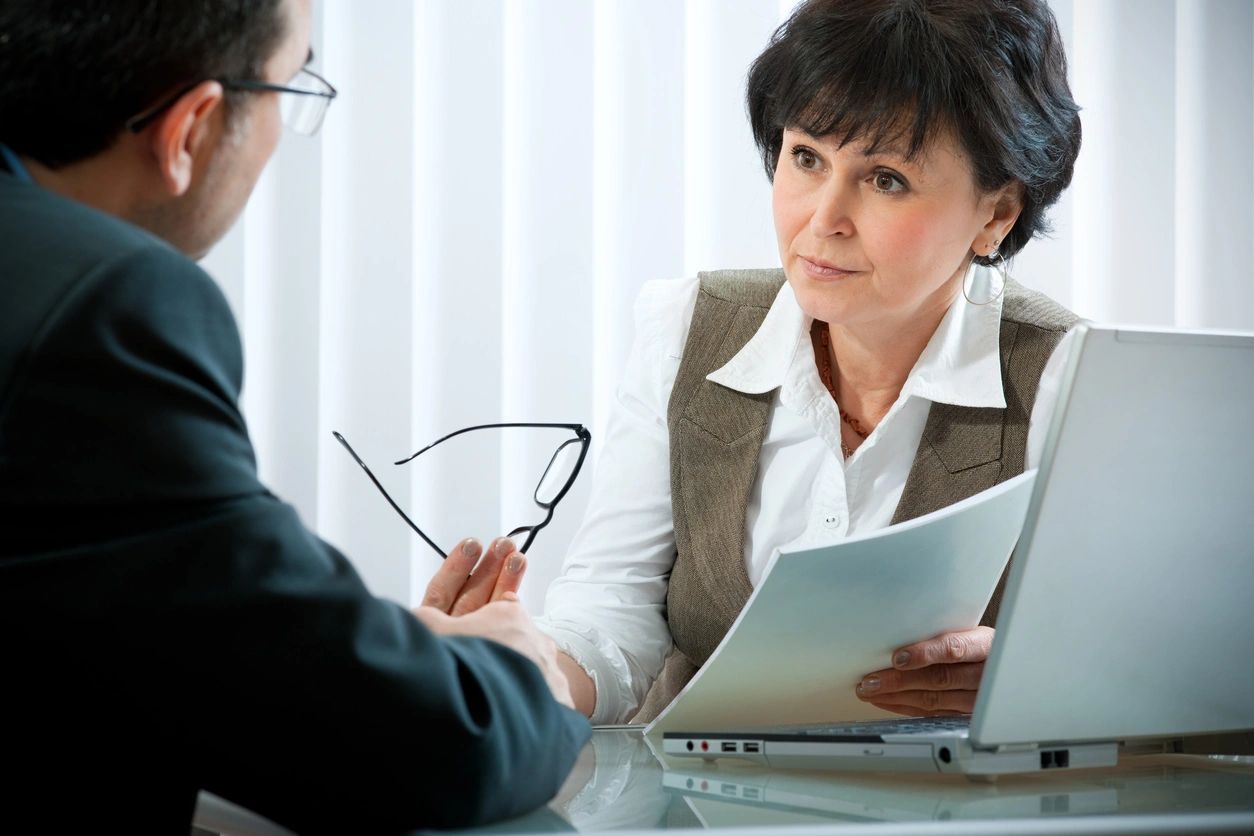 A woman is talking to an older man